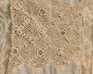 Closeup of vintage early 20th century sleeveless slip or chemise with hand crocheted lace