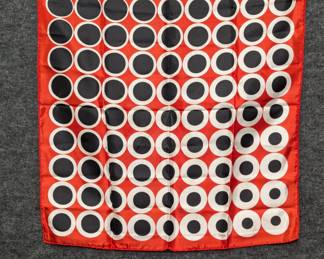 A vintage red silk scarf featuring a geometric black-and-white "circles" design