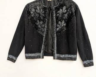 A vintage black cardigan sweater from India House, Hong Kong, decorated with black and silver sequins in floral patterns
