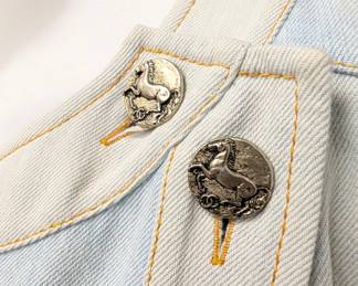 Closeup of the Chanel Paris-Greece collection light blue denim shift dress featuring cap sleeves and silver-tone CC logo buttons, size 44