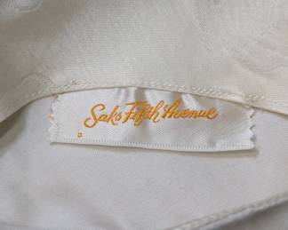 Closeup of the 1950s-60s vintage cream floral brocade cap sleeve dress and jacket, Saks Fifth Avenue label
