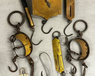 A collection of antique brass and iron spring balance scales, also known as mancur scales; includes a square brass scale marked "Chatillon's Spring Balance" from New York and a 19th century English C-Spring Scale called the "Mancur Balance"