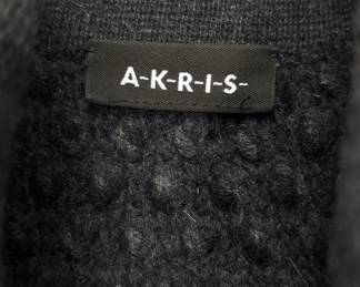 Closeup of AKRIS women's black woven sweater jacket