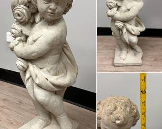 A classic concrete garden cherub or putti statue, likely representing the season of "Spring" and holding a garland of flowers