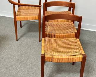 Beautiful Danish Mid Century Modern furniture: A Danish modern model 113 armchair in oak & cane by Nanna Ditzel for Kolds Savvaerk, Denmark, c. 1950's; and three Nanna and Jorgen Ditzel teak and cane dining chairs, circa 1955