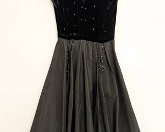 vintage 1950s black cocktail dress featuring a velvet bodice and a full taffeta skirt with rhinestone accents