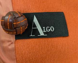 Closeup of inside tag on Algo women's green blazer with contrasting velvet trim and orange piping, structured collar