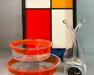 Two art glass bowls designed by Swiss multimedia artist Katja Loher for Fenton, a decorative serving tray designed in the style of Piet Mondrian's composition paintings, a vintage, hand-blown glass oil and vinegar cruet set, often referred to as a double cruet or decanter, and a Howard Miller post-modern Lucite desktop clock