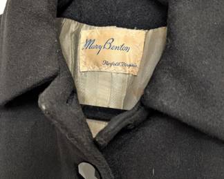 Closeup of vintage 1950s style black wool princess coat, inside tailor's label from Mary Benton, Norfolk Virginia