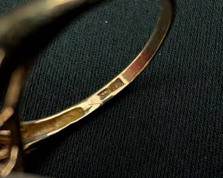 Closeup of 14k yellow gold sapphire and diamond floral cluster setting ring