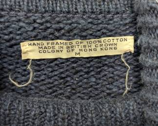 Closeup of navy blue turtleneck sweater, textured cotton knit, (often referred to as a fisherman's or submariner style sweater), size M, made in Hong Kong