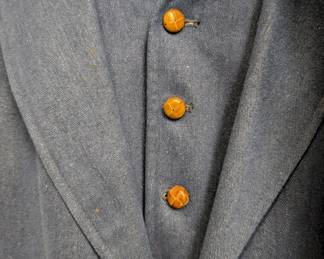 Closeup of the incredible 1970s men's denim three-piece suit with leather-covered buttons; inside label from Brittany Ltd. Chicago. 