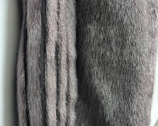Closeup of the seal fur long coat with fox fur shawl collar, inside label from the German company Fleiner in Recklinghausen.