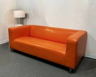 Bright orange couch for that retro vibe