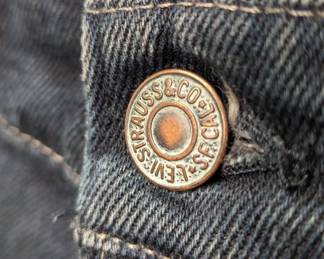 Closeup of the pair of black denim Levi jeans