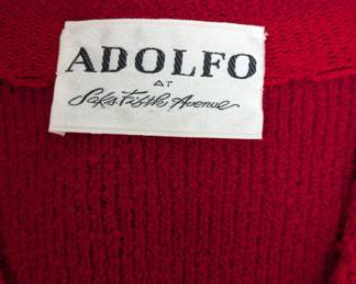 Closeup of the Adolfo bright red button-embellished knit cardigan or jacket featuring four front pockets