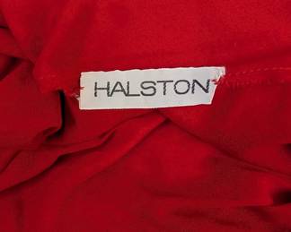 Closeup of the 1970s vintage Halston one shoulder red jersey Grecian toga style maxi gown