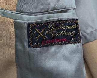 Closeup of a vintage 1970s camel brown men's suit, a blazer jacket and matching trousers