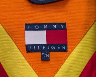Closeup of vintage Tommy Hilfiger men's yellow, orange, and red color-blocked jacket, size M