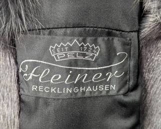 Closeup of the seal fur long coat with fox fur shawl collar, inside label from the German company Fleiner in Recklinghausen.