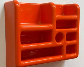 A 1960s-70s era vibrant orange Space Age style wall-mounted storage rack from Morphy Design, with a groovy smooth, curved aesthetic!