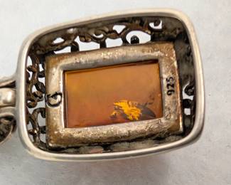 Closeup of the sterling silver and amber pendant necklace
