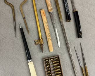 A vintage brass and stainless steel nautical navigators chart map divider, a vintage Japanese souvenir letter opener set in form of a Tanto sword, a vintage miniature brass abacus