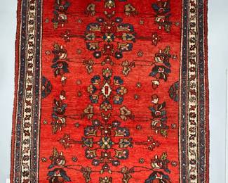 A vintage hand-knotted Persian Hamadan rug with a red pile and blue floral motifs, approximately 4' x 6'