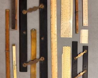 A collection of antique measuring and drawing instruments, primarily used in cartography, engineering, and drafting; includes antique boxwood folding rules with brass hinges, parallel rules, and sliding scales, one marked Murray & Heath Jermyn St. London, and one marked Ash & Son Bull St. Birmingham
