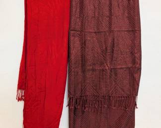 A vibrant red fringed scarf and a deep russet color brocade patterned fringed scarf