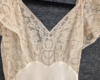 Closeup of a vintage 1940s nightgown with lace accents, silk or a silk rayon mix