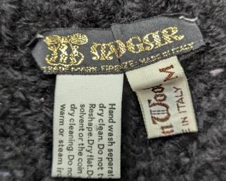 Closeup of black wool cable knit Aran-style or fisherman's-style sweater, made in Italy