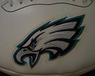 Closeup of the Philadelphia Eagles commemorative logo football featuring the team's championship history printed on the white panel. 
