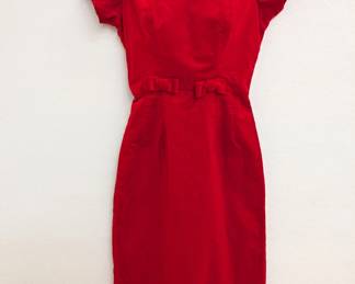 A vintage cherry red velvet dress with short sleeves and velvet bows at the waist