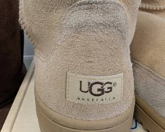 Closeup of one of three pair of men's UGG leather boots, in black, brown, and tan