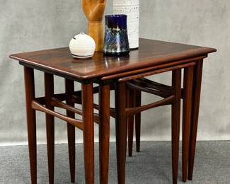 A beautiful set of Danish modern rosewood nesting tables, 1960s, set of 3. Graceful clean mid-century-modern lines, largest table is 15"W x 22-1/2"L x 19"H.