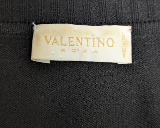 Tag inside the Valentino sheer sleeve black top