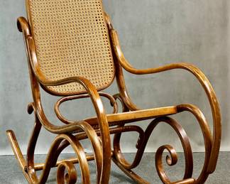 One of two vintage Thonet-style bentwood rocking chair with rattan back and seat