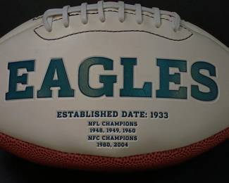 Closer view of the Philadelphia Eagles commemorative logo football featuring the team's championship history printed on the white panel. 