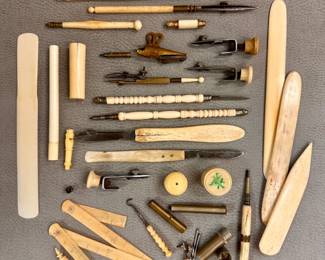 A collection of antique and vintage bone handled sewing and drawing/drafting tools along with flat book folders or creasers used in bookbinding and paper crafts