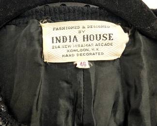 Closeup of vintage black cardigan sweater from India House, Hong Kong, decorated with black and silver sequins in floral patterns