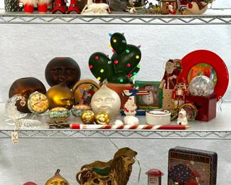 A collection of vintage holiday decorations including hand-blown glass Christmas ornaments, tabletop displays, advertising tins 