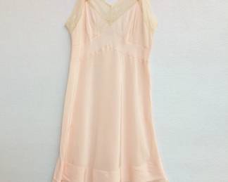 A vintage Lady Pembrooke peach color rayon and ecru lace slip