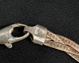 Closeup of two sterling silver braided herringbone chain necklaces