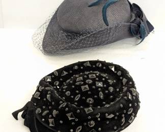 A vintage Gwenn Pennington gray fascinator hat with netting and blue feathers, and a vintage Corona 1950s-1960s black velvet pillbox hat with faceted beads, made in Italy