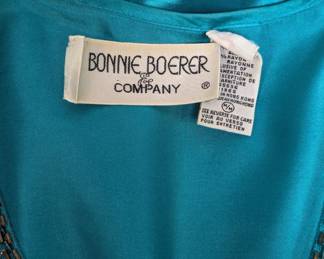 Closeup of Bonnie Boerer vintage 1980s butterfly sweater, turquoise with embroidery and sequins, size medium