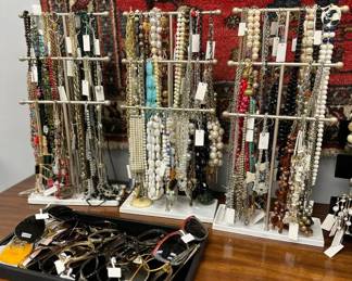 Costume jewelry - lots of necklaces from beaded to rhinestone to chains; bracelets, and a selection of sunglasses and eye glass frames