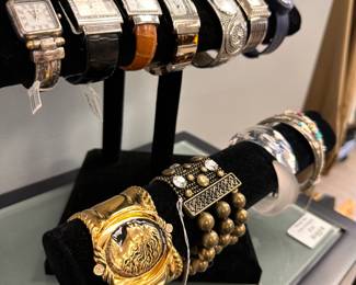 Fashion bracelets and dress wristwatches including a vintage Coreen Simpson Regal Beauty cuff bracelet and a Lucien Picard stainless steel watch