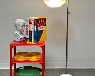 A Heller magazine rack/book holder, a Demetrio 45 red plastic three-tier side table by Artemide Milano, and a 1970s mid century modern Fabio Lenci focus floor Lamp for Harvey Guzzini, steel and white perspex with adjustable lampshade.