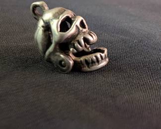 A sterling silver skull charm, marked 925